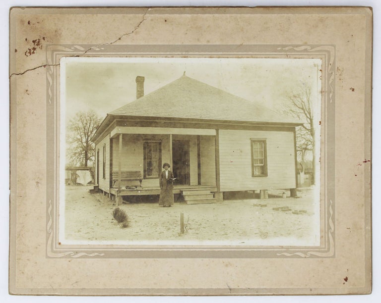 Item #4450 [Cabinet Card Photograph Capturing an African American Woman Holding an Open Book Outside Her Home]. African Americana, Photography.